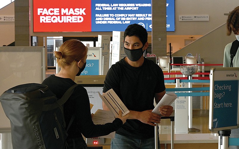 (From left) Nicole Freeman, Adam Gomez, and Jake Coddington wait in line to check in to their flight at the Clinton National Airport in Little Rock on Tuesday, Feb. 2, 2021. President Biden's national mask mandate went into effect last night at 11:59. 

(Arkansas Democrat-Gazette/Stephen Swofford)