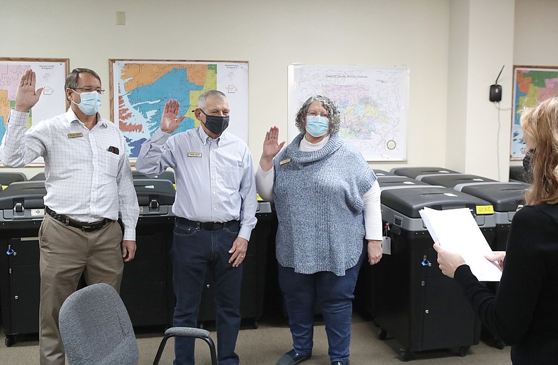 County Clerk Sarah Smith, right, swears in Garland County Election Commission members Ralph Edds, left, Gene Haley and Kay Ekey Wednesday at the Election Commission Building. - Photo by Richard Rasmussen of The Sentinel-Record