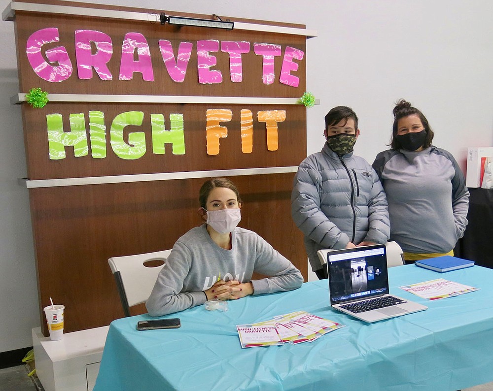 Westside Eagle Observer/SUSAN HOLLAND
Chanel Tergneer, Tanner Lundquist and Neka Lundquist pose for the camera as they man the Gravette High Fitness booth at the grand opening of the Gravette Gym Saturday, Feb. 6. Instructors from High Fitness are conducting aerobics classes on Tuesday and Thursday evenings at the gym.