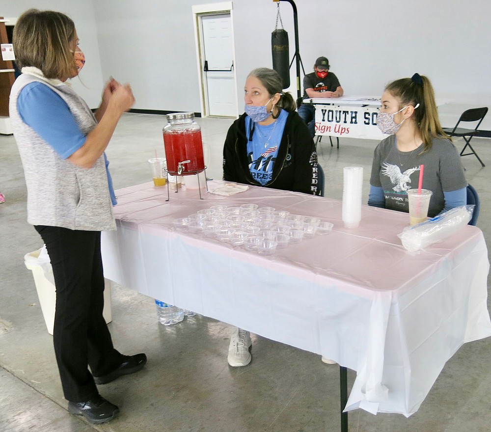 Westside Eagle Observer/SUSAN HOLLAND
Marisa Crain of Bella Vista, owner of the newly-opened business Gravette Nutrition, and her helper Kaitelyn Trimble of Gravette, visit with a local resident as they man the Gravette Nutrition booth at the grand opening of the Gravette Gym Saturday, Feb. 6.