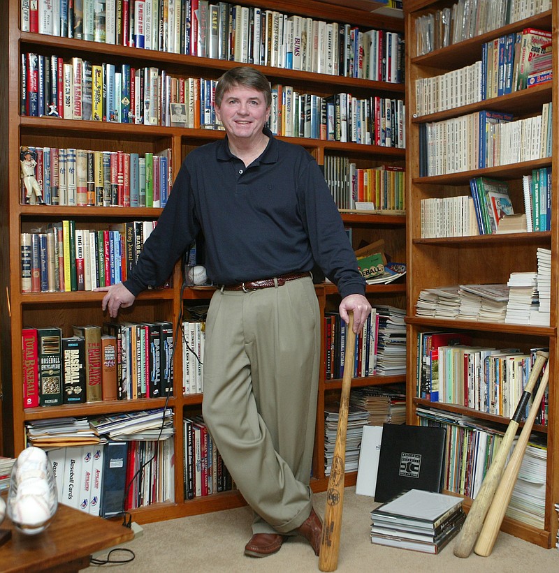 Mike Dugan, of Hot Springs, stands in a room full of his sports memorabilia on Dec. 28, 2009. - Photo by Richard Rasmussen of The Sentinel-Record