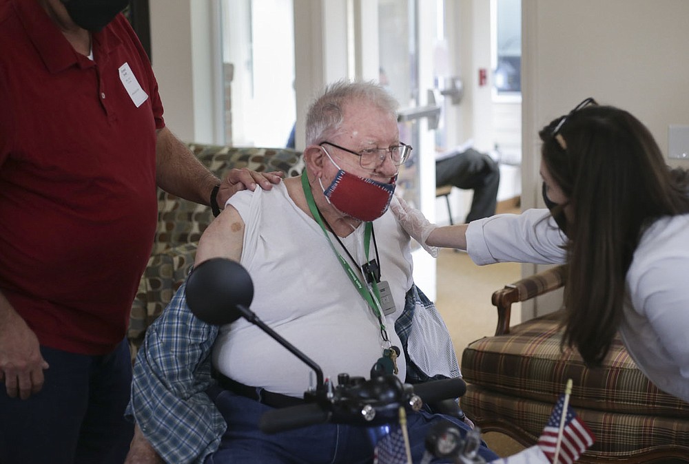 Nurse Brenna Neumann (right) talks to George Engle (center) before administering his covid-19 vaccine, Friday, February 5, 2021 at Apple blossom retirement community in Rogers. Forty residents at Apple Blossom retirement community received their covid-19 vaccines. Check out nwaonline.com/210206Daily/ for today's photo gallery.
(NWA Democrat-Gazette/Charlie Kaijo)