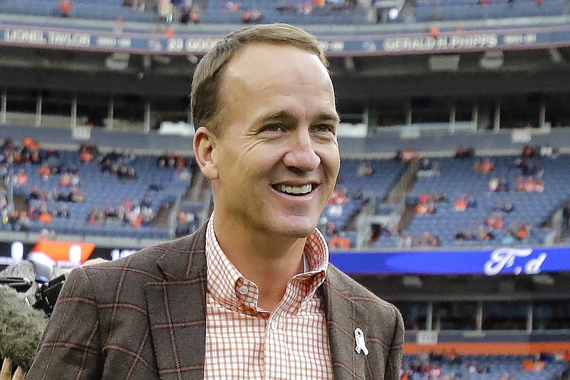 FILE - Former Denver Broncos quarterback Peyton manning talks prior to an NFL football game between the Denver Broncos and the Houston Texans in Denver, in this Sunday, Nov. 4, 2018, file photo. More than two decades ago Charles Woodson beat out Peyton Manning for a prestigious college award. Something called the Heisman Trophy. On Saturday, Feb. 6, 2021, they likely will share an even more impressive football honor: entry into the Pro Football Hall of Fame.  (AP Photo/Jack Dempsey, File)