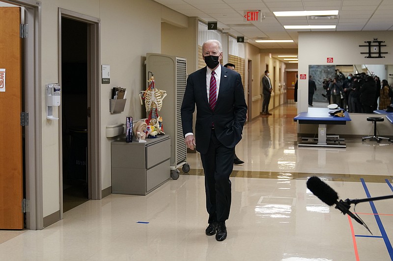 FILE - In this Jan. 29, 2021, file photo members of the media are reflected in a mirror as President Joe Biden arrives at Walter Reed National Military Medical Center in Bethesda, Md. (AP Photo/Alex Brandon, File)