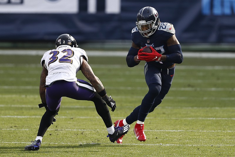 Tennessee Titans running back Derrick Henry (22) carries the ball against Baltimore Ravens free safety DeShon Elliott (32) in the second half of an NFL wild-card playoff football game Sunday, Jan. 10, 2021, in Nashville, Tenn. (AP Photo/Wade Payne)
