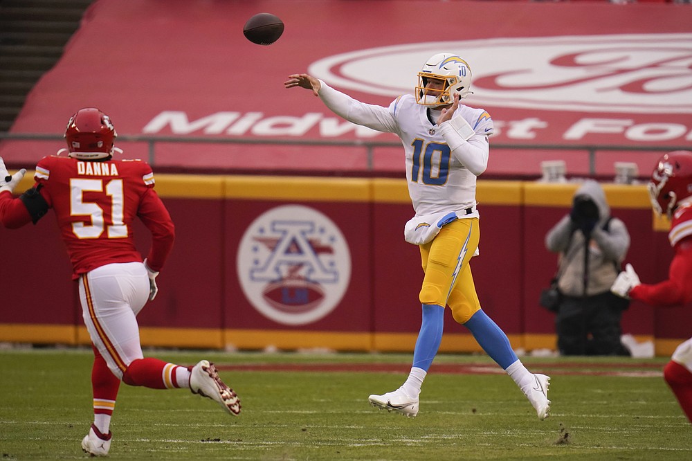 Los Angeles Chargers quarterback Justin Herbert throws a pass over Kansas City Chiefs defensive end Mike Danna (51) during the first half of an NFL football game, Sunday, Jan. 3, 2021, in Kansas City. (AP Photo/Jeff Roberson)