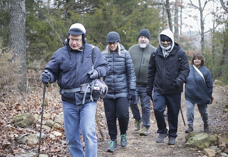 Greg Zeck (from left) leads hikers, Anne Neumann, Bryan Fleming, Pavan Pelluru and Claudia Garcia, Sunday, February 7, 2021 at the Bayyari Park hiking trail in Springdale. Springdale has six trail projects in some stage of planning or construction and has allocated all of its money available this year for the projects. Check out nwaonline.com/210208Daily/ for today's photo gallery. 
(NWA Democrat-Gazette/Charlie Kaijo)