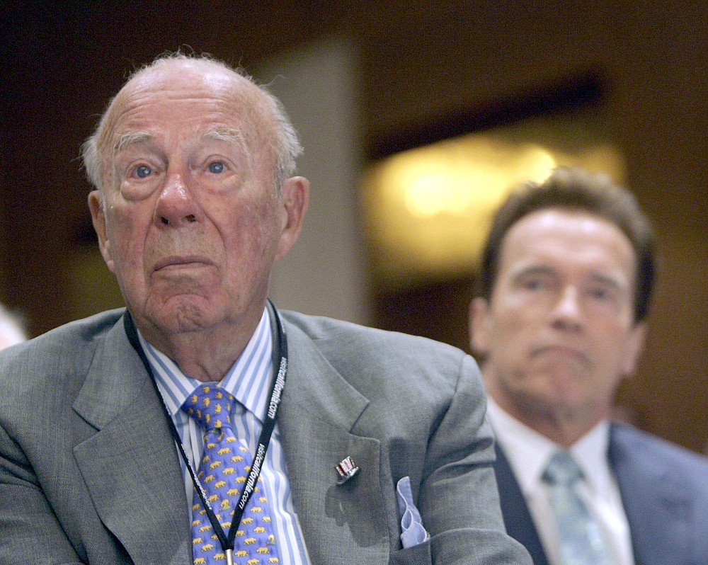 FILE - In this Aug. 14, 2008 file photo, former Secretary of State, George Shultz, left, and California Gov. Arnold Schwarzenegger, listen during the opening of the 26th Border Governors Conference, in Los Angeles. Shultz, former President Ronald Reagan’s longtime secretary of state, who spent most of the 1980s trying to improve relations with the Soviet Union and forging a course for peace in the Middle East, died Saturday, Feb. 6, 2021. He was 100. (AP Photo/Nick Ut, File)