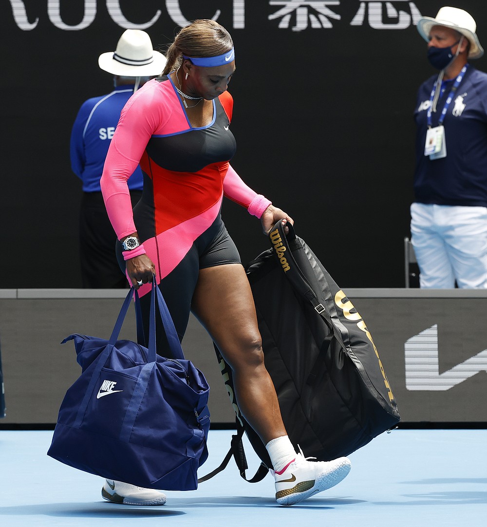 United States' Serena Williams carries her bags as she leaves th court after defeating Germany's Laura Siegemund in their first round match at the Australian Open tennis championship in Melbourne, Australia, Monday, Feb. 8, 2021.(AP Photo/Rick Rycroft)