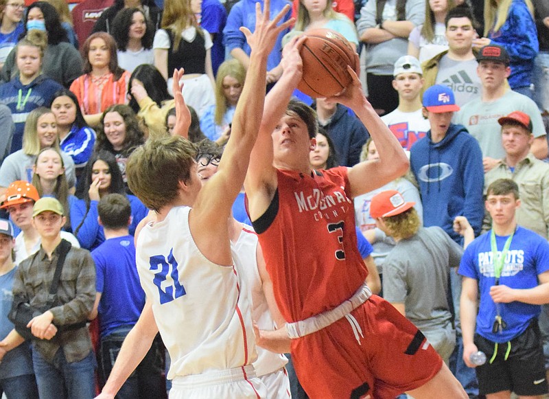 RICK PECK/SPECIAL TO MCDONALD COUNTY PRESS McDonald County guard Pierce Harmon drives past East Newton's Gabe Bergen for a basket during the Mustangs' 75-58 loss on Aug. 5 at East Newton High School.