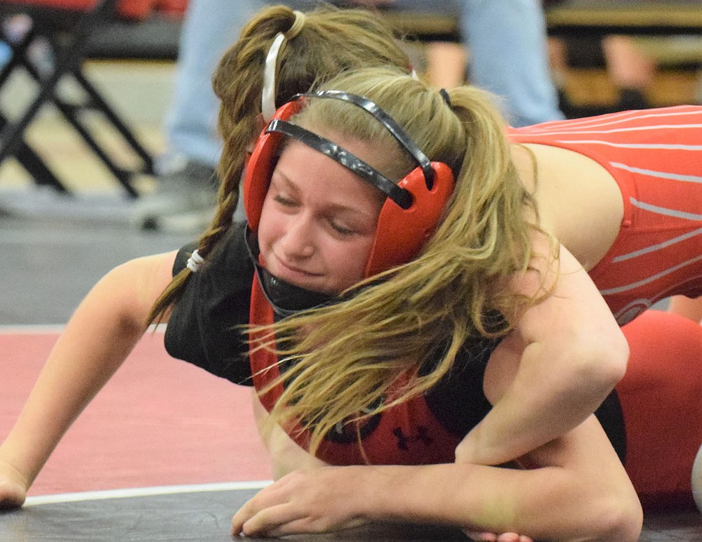 RICK PECK/SPECIAL TO MCDONALD COUNTY PRESS McDonald County's Jaslyn Benhumea tries to fight off Ashlyn Eli of Nixa in a 102-pound match at the Missouri Class1 District 5 Girls Wrestling Tournament held on Feb. 5-6 at MCHS. The undefeated Eli went on to pin Benhumea, but the McDonald County freshman won her next match to take third place.