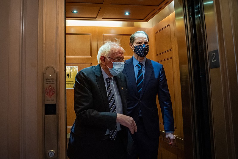 U.S. Sen. Bernie Sanders, I-Vt., and Sen. Ron Wyden, D-Ore., make their way to the Senate floor on the U.S. Capitol Hill on Tuesday, January 26, 2021 in Washington, D.C. MUST CREDIT: Washington Post photo by Salwan Georges