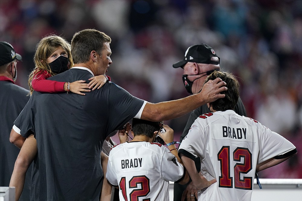 Tampa Bay Buccaneers quarterback Tom Brady celebrates with his children after the NFL Super Bowl 55 football game against the Kansas City Chiefs, Sunday, Feb. 7, 2021, in Tampa, Fla. The Buccaneers defeated the Chiefs 31-9 to win the Super Bowl. (AP Photo/Mark Humphrey)