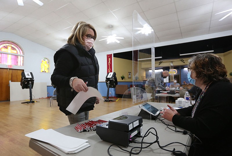 Julia Williams (left) is assisted by Beth Swearingen, an election official with Washington County, Tuesday, February 9, 2021, as she she receives her ballot at the Main Street Baptist Church in Farmington. Patrons in Farmington and Prairie Grove residents are being asked to approve construction projects. A special election in Gentry will determine the sale of alcohol on Sundays within the city limits. Check out nwaonline.com/210210Daily/ and nwadg.com/photos for a photo gallery.
(NWA Democrat-Gazette/David Gottschalk)