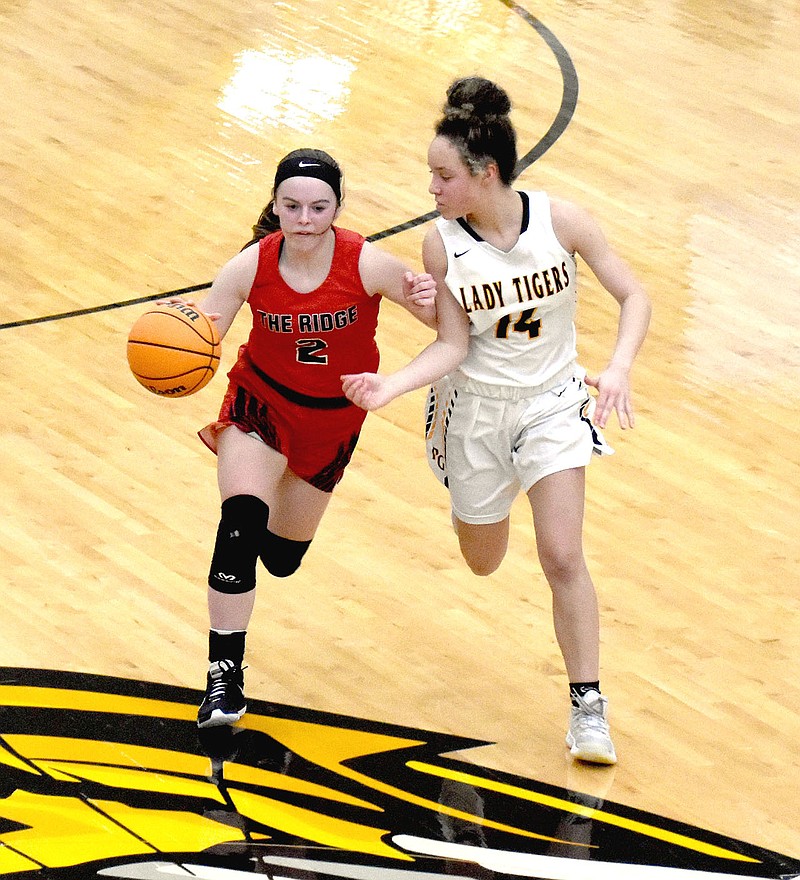 MARK HUMPHREY  ENTERPRISE-LEADER/Pea Ridge freshman Leah Telgemeier brings the ball up against pressure by Prairie Grove junior Trinity Dobbs. Telgemeier scored 13 points to lead the Lady Blackhawks in a 65-38 girls basketball win at Tiger Arena on Tuesday, Feb. 9.