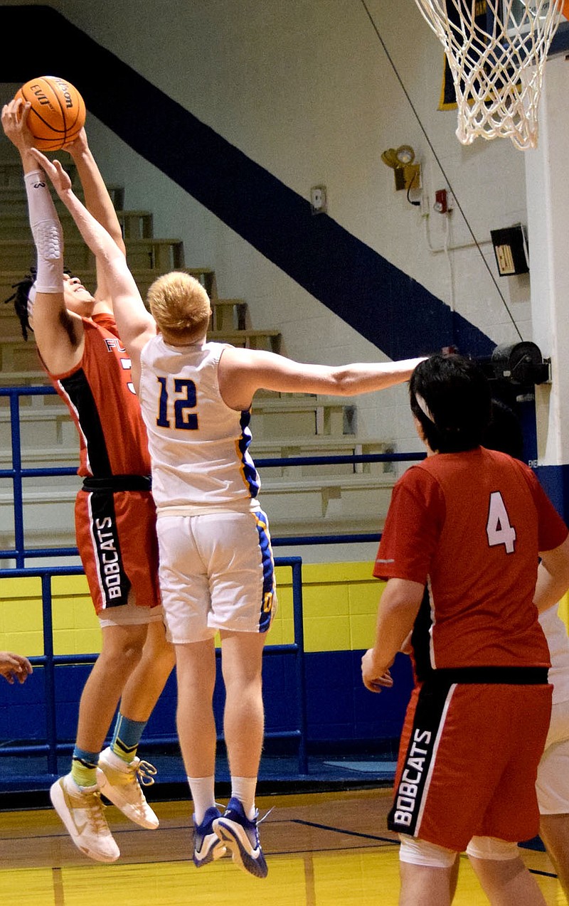 Westside Eagle Observer/MIKE ECKELS

Bryson Funk (Decatur 12) goes up with Bobcat Paul Hart's who attempts a jumper from the left side of the key during the Decatur-Flippin conference basketball contest at Peterson Gym in Decatur Feb. 9.