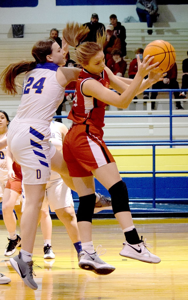 Westside Eagle Observer/MIKE ECKELS
Lady Bulldog Abigail Schopper (left) tries to strip the ball away from Lady Bobcat Ella Alexander (center) during the first quarter of the Decatur-Flippin conference basketball game in Decatur Feb. 9. Alexander ended up missing her layup and losing the ball near the line but a teammate picked up the rebound for the Lady Bobcats.