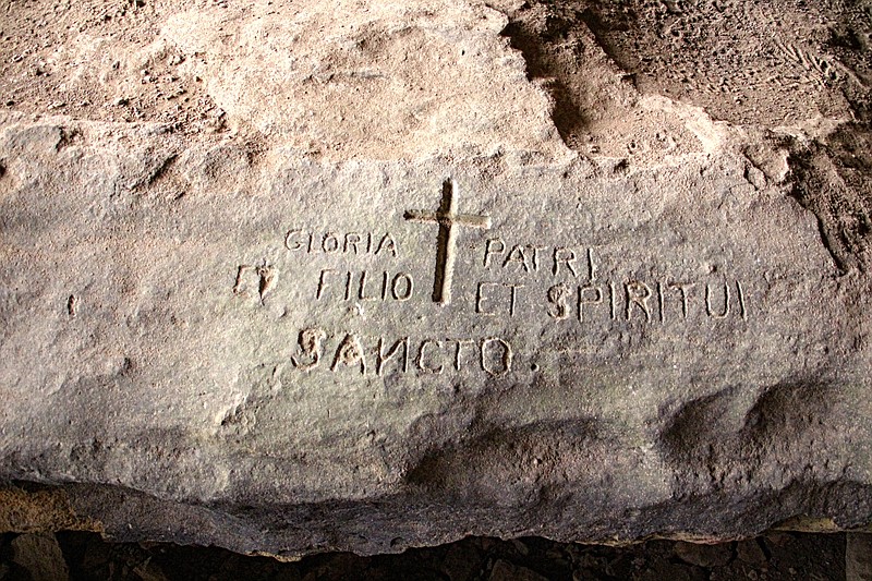 The origin of this Latin inscription, carved into stone in a shelter on Home Valley Bluff, is one of the mysteries of the Ozark National Forest. (Special to the Democrat-Gazette/Bob Robinson)