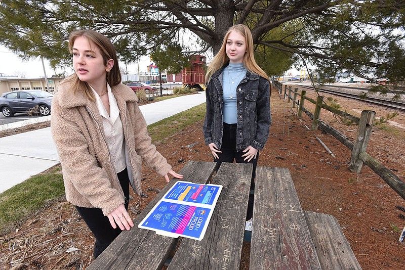 Betty Gower (left), 17, and Grace Henley, 18, talk Saturday Feb. 6 2021 in downtown Rogers about their LGBTQ Rogers High School yearbook proposal.
(NWA Democrat-Gazette/Flip Putthoff)