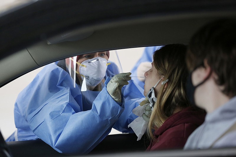 Jillian Brugger, a junior at the University of Arkansas, is tested for covid-19 Jan. 6, 2021, during a drive-up testing clinic hosted by the Arkansas Department of Health in the parking lot across from Baum-Walker Stadium at the corner of Razorback Road and 15th Street in Fayetteville. (File photo/NWA Democrat-Gazette/David Gottschalk)