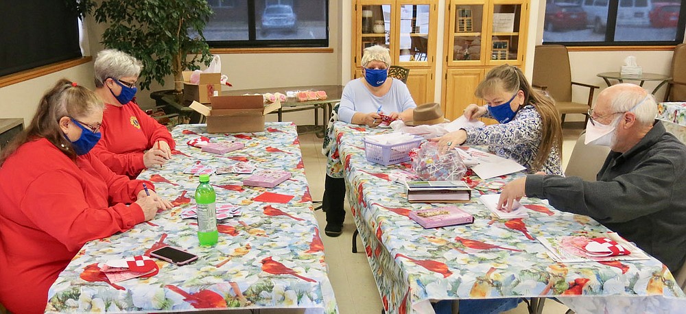 Westside Eagle Observer/SUSAN HOLLAND
Members of the Gravette Lions Club assemble valentines at the Billy V. Hall Senior Activity Center Tuesday afternoon, Feb. 9. Lions held a work session at the Center to fill envelopes with valentines, lollipops and handmade beaded hearts. The treats were distributed to Senior Center patrons with their Valentine's Day takeout meals on Friday. Pictured are Lions Snooky Garrett, Sue Rice, Melissa Williams, Linda Damron and Jeff Davis.