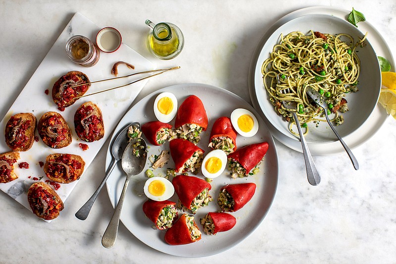 From left, Crostini With Sun-Dried Tomato and Anchovy, Tuna-Stuffed Piquillo Peppers, and Spicy Clam Pasta With Bacon, Peas and Basil. Eat them separately, or, do as David Tanis does, and make them a whole meal. (The New York Times/Andrew Scrivani)