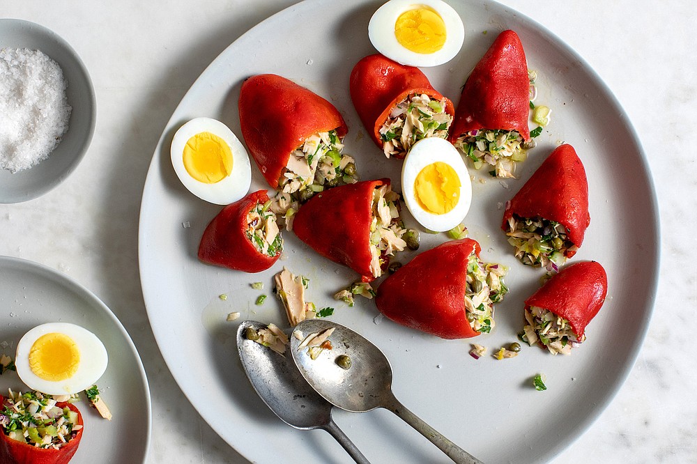 A few of these Tuna-Stuffed Piquillo Peppers make a zesty first course, served with crisp lettuce leaves and hard-cooked egg. (The New York Times/Andrew Scrivani)