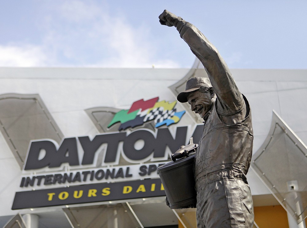 FILE - In this Feb. 16, 2011, file photo, a statue of Dale Earnhardt rises above an entrance at Daytona International Speedway in Daytona Beach, Fla. On the cusp of a national popularity explosion, NASCAR never stopped after the deaths of Adam Petty, Kenny Irwin Jr. and Tony Roper. But losing Earnhardt forced the stock car series to confront safety issues it had been slow to even acknowledge, let alone address. The dramatic upgrades have saved multiple lives — NASCAR has not suffered a racing death in its three national series since — and are the hallmark of Earnhardt's legacy. (AP Photo/Lynne Sladky, File)