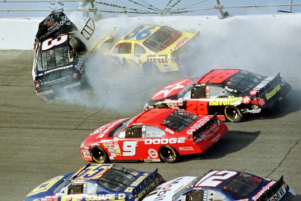 FILE - In this Feb. 18, 2001, file photo, Dale Earnhardt's (3) window pops out of the car after being hit by Ken Schrader (36) during the Daytona 500 auto race at Daytona International Speedway in Daytona Beach, Fla. On the cusp of a national popularity explosion, NASCAR never stopped after the deaths of Adam Petty, Kenny Irwin Jr. and Tony Roper. But losing Earnhardt forced the stock car series to confront safety issues it had been slow to even acknowledge, let alone address. The dramatic upgrades have saved multiple lives — NASCAR has not suffered a racing death in its three national series since — and are the hallmark of Earnhardt's legacy. (AP Photo/Greg Suvino, File)