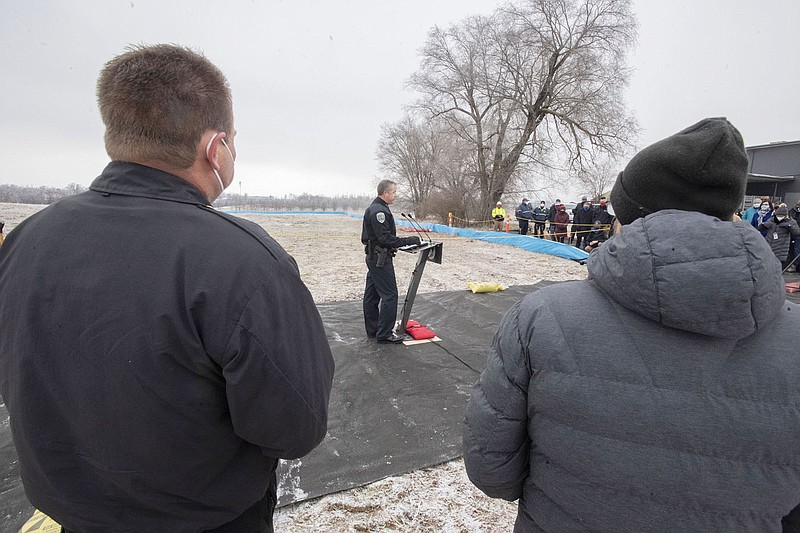 Fayetteville Fire Chief Brad Hardin (left) and mayor Lioneld Jordan watch as police chief Mike Reynolds speaks Thursday during a ground breaking ceremony for a new police headquarters and fire substation near Porter Road and Deane Street. Voters in 2019 approved a nearly $37 million bond issue to build a new headquarters for the city's Police Department, as well as a fire substation. The headquarters will include a new main station to replace the station on Rock Street, an indoor firing range and more space for vehicle and evidence storage. Visit nwaonline.com/210111Daily/ and nwadg.com/photos. (NWA Democrat-Gazette/J.T. Wampler)