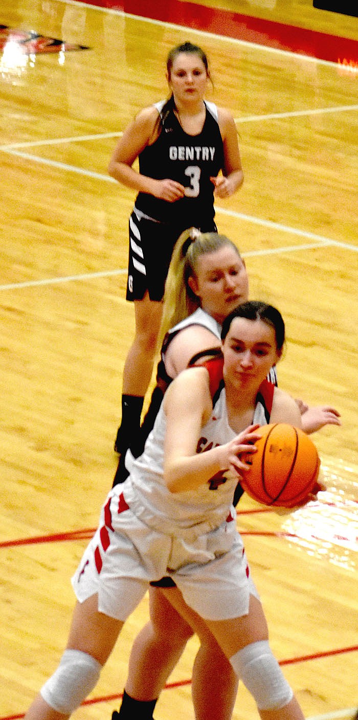 MARK HUMPHREY ENTERPRISE-LEADER/Farmington junior Morgan Brye hangs onto a defensive rebound with Gentry's 6-0 Emily Toland crashing the offensive glass.
Farmington didn't play its best game, yet held off the Lady Pioneers during a Tuesday, Feb. 9 girls basketball, 46-32, win at Cardinal Arena.