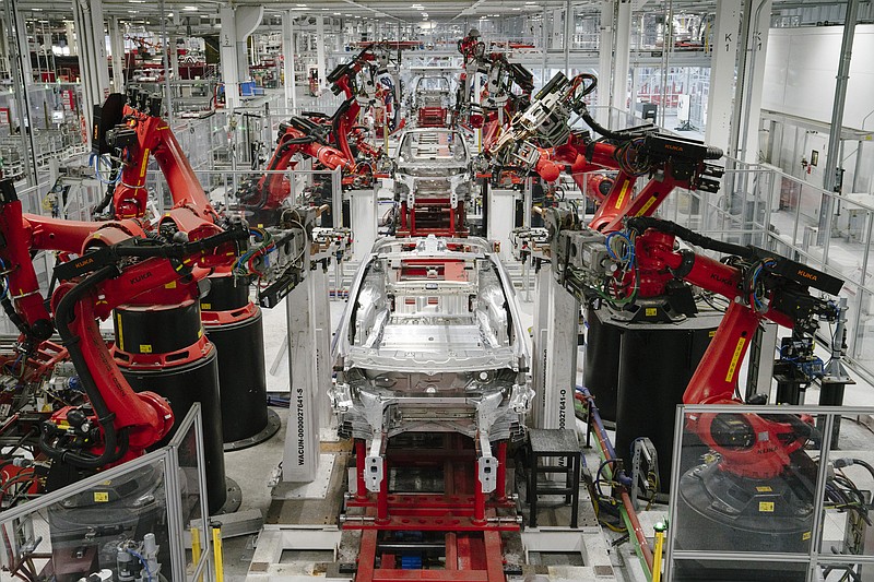 Robots work on Model X cars in the Tesla factory in Fremont, Calif., in 2018. MUST CREDIT: Photo for The Washington Post by Mason Trinca