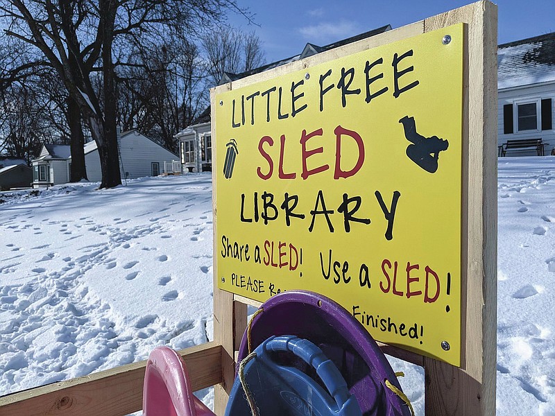 Sleds stand in the Little Free Sled Library on Monday, Jan. 25, 2021, in Ventura, Iowa. The Little Free Sled Library was built and installed near the Ventura sledding hill by Tory Reiman and Bob Rolling, of Clear Lake, after Jessica Wood presented the idea on social media. (Ashley Stewart/Globe-Gazette via AP)