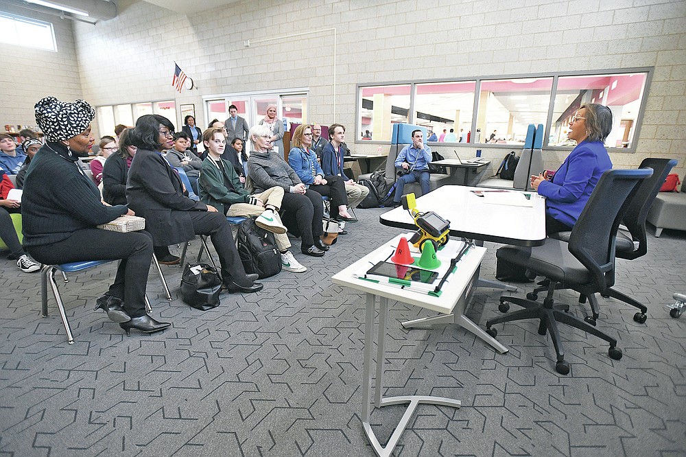 U.S. Rep. Robin Kelly visits Kankakee High School to recognize freshman David Love, at center in front row with his family, on his project that won the 2019 Congressional App Challenge for Illinois' 2nd Congressional District, Monday, Feb. 24, 2020 in Kankakee, Ill. (Tiffany Blanchette/The Daily Journal via AP)