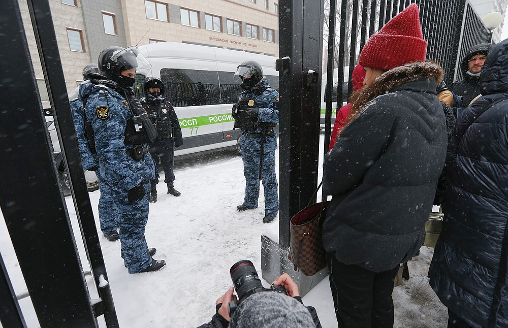 Police officers stand guard at the Babuskinsky district court prior to the start of the trial against Russian opposition leader Alexey Navalny in Moscow, Russia, Friday, Feb. 12, 2021. Navalny was accused of slandering a World War II veteran featured in the video promoting the constitutional reform allowing to extend President Vladimir Putin's rule. The politician slammed people in the video as "corrupt stooges" and "traitors." (AP Photo/Alexander Zemlianichenko)
