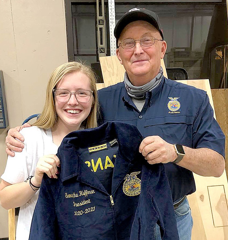 PRHS FFA president Samantha Huffman received her jacket from teacher Perry Mason.