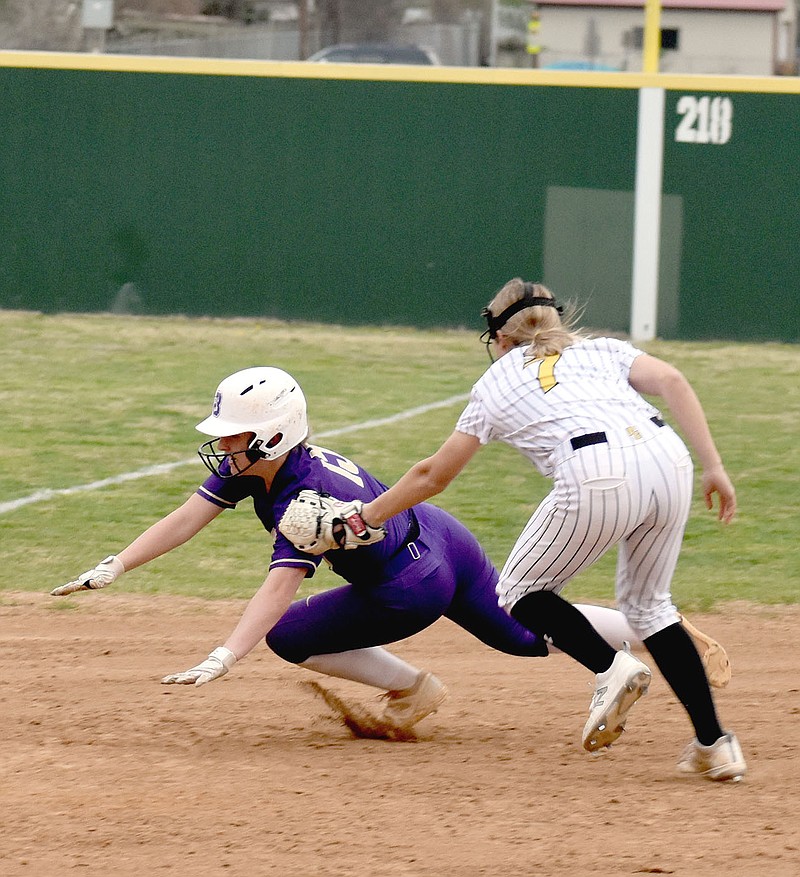 MARK HUMPHREY  ENTERPRISE-LEADER/Prairie Grove sophomore Kaylee Kincaid, playing shortstop, tags out Berryville's Emily Utt before she can get to third. Utt doubled to lead off the top of the seventh with the Lady Bobcats leading 5-2, but was put out when LoraGrace Hill hit into a fielder's choice and Kincaid had the presence of mind to tag out the lead runner instead of throwing to first. Berryville coach Josh Hatfield felt the base-running error cost the Lady Bobcats at least two runs and the game, which Prairie Grove rallied to win 6-5.
