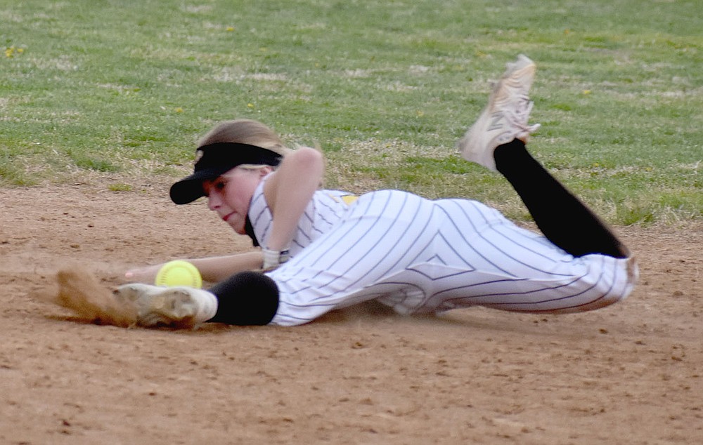 MARK HUMPHREY ENTERPRISE-LEADER/Prairie Grove senior Sydney Stearman bites the dust to stop the softball in the infield, illustrating the type of effort required of the Lady Tigers in overcoming a 5-2 deficit against Berryville going into the seventh inning. Stearman's valiant defensive play contributed to Prairie Grove's 6-5 comeback victory on Tuesday, March 30.