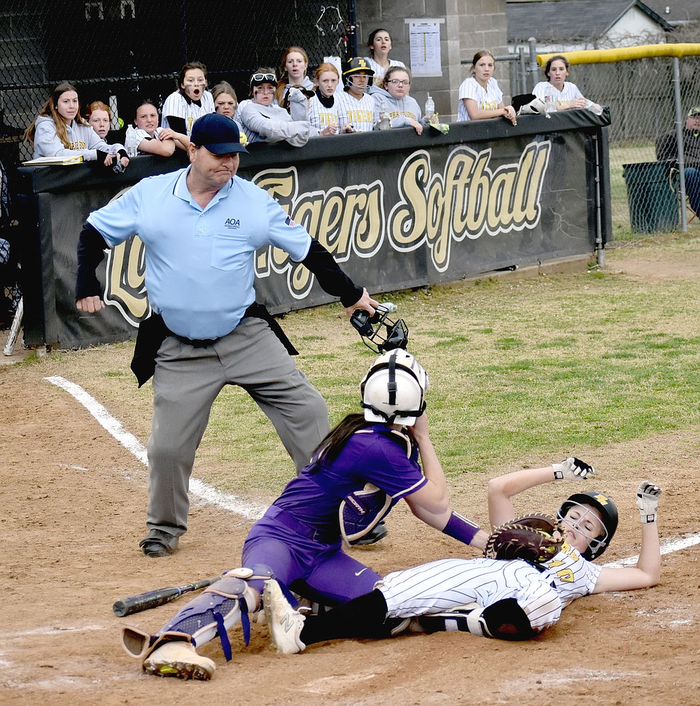 MARK HUMPHREY ENTERPRISE-LEADER/The Berryville catcher applies a tag to Prairie Grove senior Sydney Stearman waved in from second by Lady Tiger coach Dave Torres with one out. The brilliant throw home by Lady Bobcats outfielder LoraGrace Hill had a downside for Berryville because it allowed Makinsey Parnell to turn a single into a double. She scored on Kelsey Pickett's double to end the game with Prairie Grove winning 6-5 after beginning the seventh inning with a 3-run deficit on Tuesday, March 30.