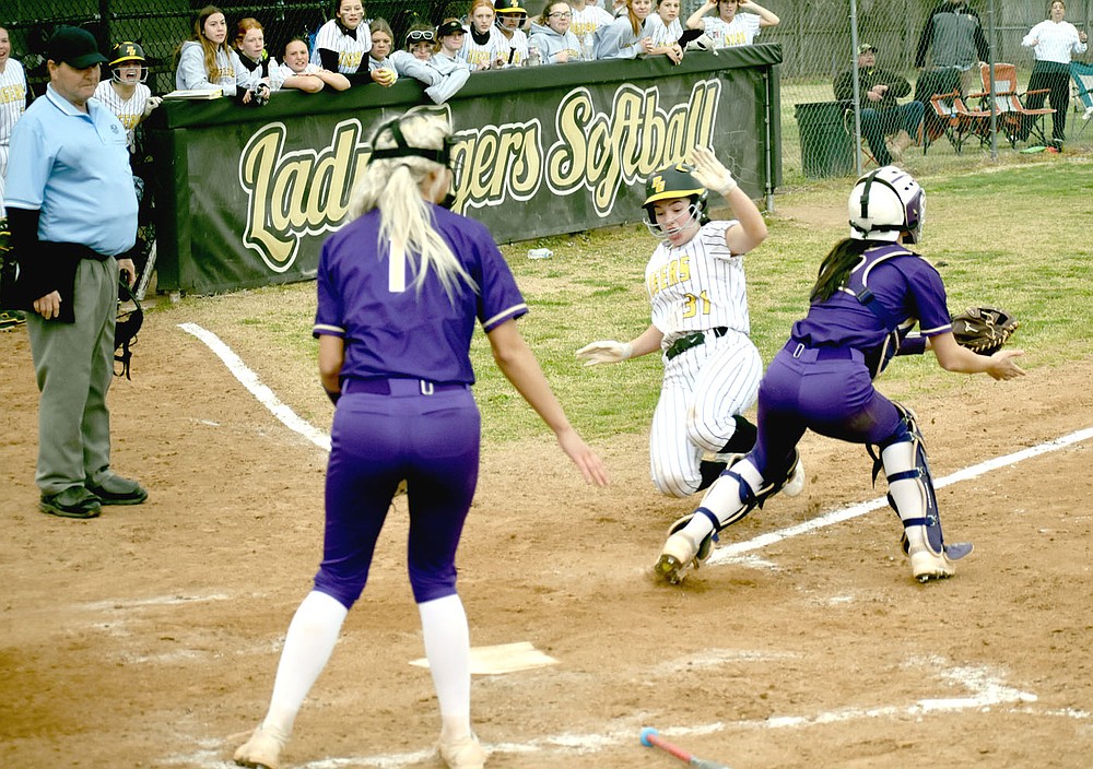 MARK HUMPHREY ENTERPRISE-LEADER/Prairie Grove senior Makinsey Parnell goes into a slide while squeezing past Berryville catcher with Lady Bobcat pitcher Faith Kelley backing up at the plate. Parnell scored the winning run on this play after delivering a base hit to keep the Lady Tigers alive in the bottom of the seventh. Kelsey Pickett doubled to bring Parnell home as Prairie Grove emerged with a 6-5 win to start 4A-1 Conference softball play.