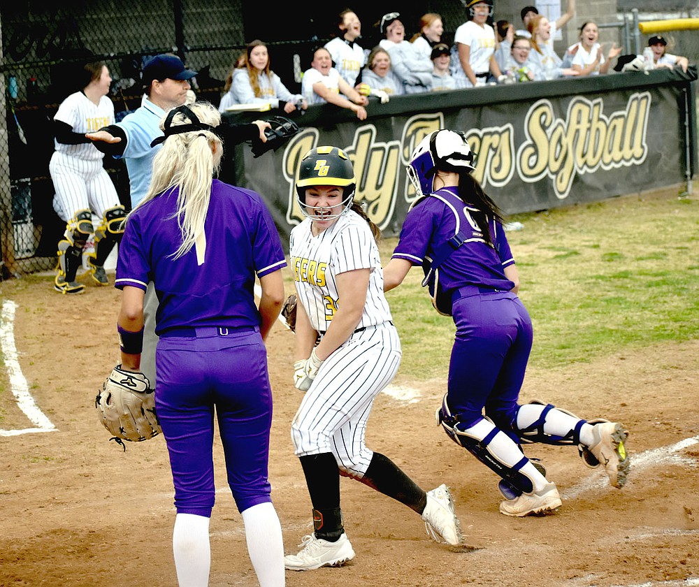 MARK HUMPHREY ENTERPRISE-LEADER/Prairie Grove senior Makinsey Parnell breaks into a jubilant smile, realizing she just scored the winning run on Kelsey Pickett's double, capping a furious Lady Tiger 4-run rally in the bottom of the seventh to open 4A-1 Conference softball play with a 6-5 win over Berryville on Tuesday, March 30.