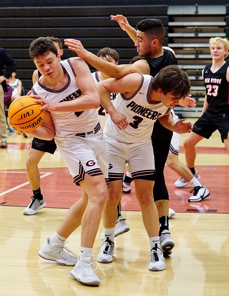 Westside Eagle Observer file photo/RANDY MOLL Gentry senior Seiren Reding, with Isaiah Lemke blocking, grabs a rebound during play against Pea Ridge in Gentry on Feb. 5.