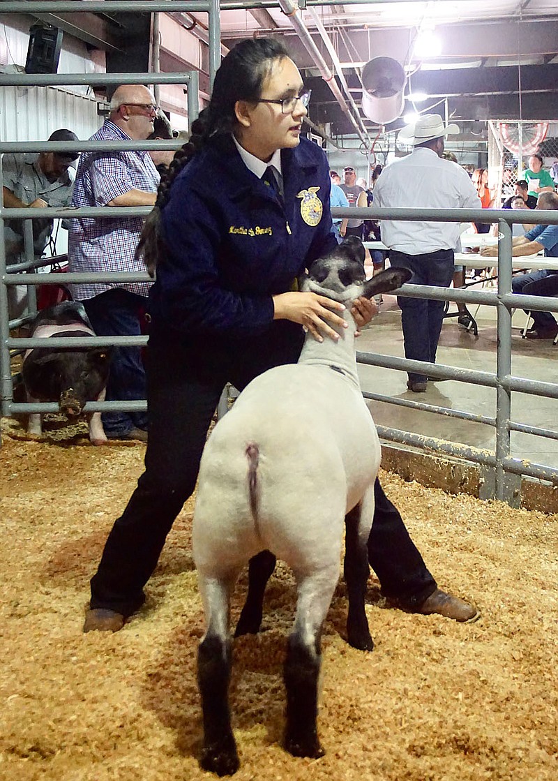 Westside Eagle Observer file photo/RANDY MOLL
Martha Gomez-Smith, Decatur FFA, shows a lamb at the Benton County Fair in 2019.