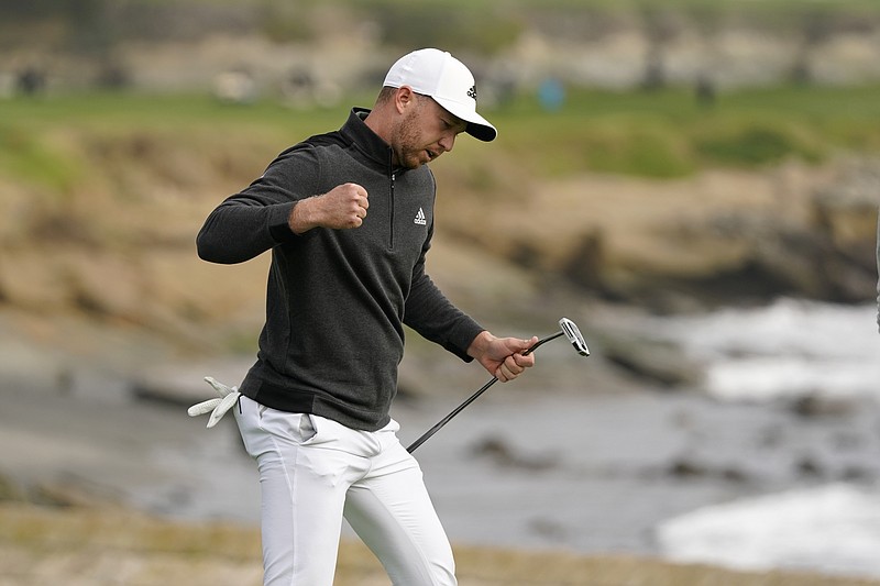 Daniel Berger reacts after making an eagle putt on the 18th green of the Pebble Beach Golf Links during the final round of the AT&T Pebble Beach Pro-Am golf tournament Sunday, Feb. 14, 2021, in Pebble Beach, Calif. Berger won the tournament. (AP Photo/Eric Risberg)