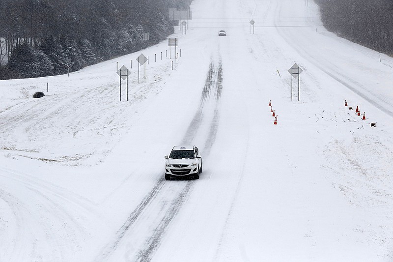 Snow continues to fall Monday, as a limited amount of traffic travels on a section of the Fulbright Expressway in South Fayetteville. The National Weather Service is forecasting several inches of snow throughout the state through Wednesday and Thursday.
(NWA Democrat-Gazette/David Gottschalk)