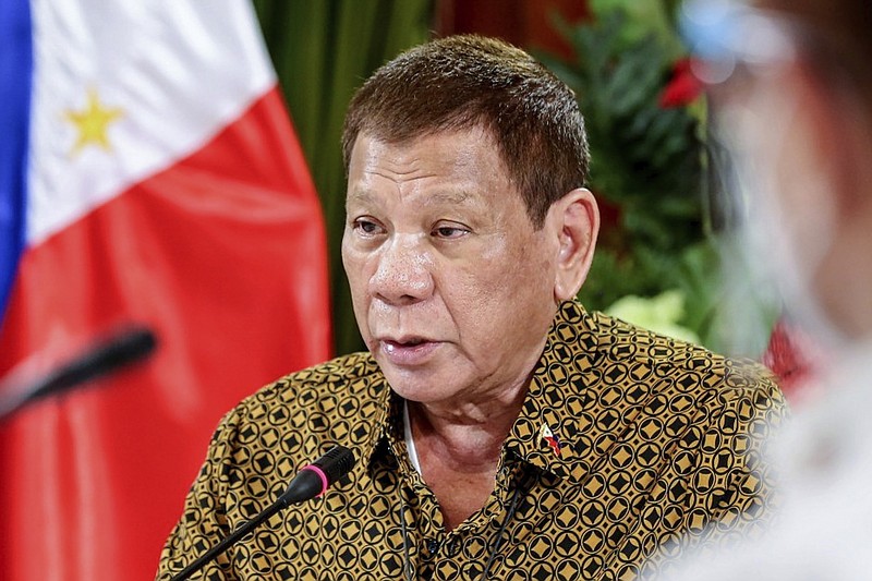 FILE - In this Sept. 28, 2020, file photo provided by the Malacanang Presidential Photographers Division, Philippine President Rodrigo Duterte talks with members of the Inter-Agency Task Force on the Emerging Infectious Diseases at the Malacanang presidential palace in Manila, Philippines. Duterte’s administration wants considerably more military aid from the United States in exchange for not abrogating a key security pact with Washington, his spokesman said Monday, Feb. 15, 2021, rejecting criticism that the blunt demand resembled extortion. (Richard Madelo/Malacanang Presidential Photographers Division via AP, File)