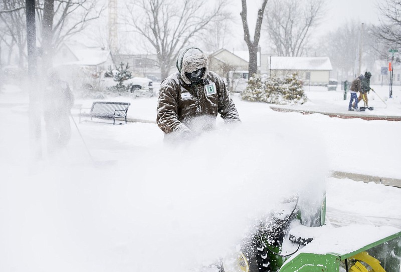 Bentonville Parks and Recreation Maintenance Crew Member Jon Wilson uses a snow plow, Monday, February 15, 2021 at Lawrence Plaza in Bentonville. Check out nwaonline.com/210216Daily/ for today's photo gallery. 
(NWA Democrat-Gazette/Charlie Kaijo)