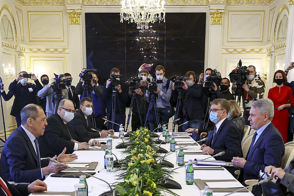 In this handout photo released by Russian Foreign Ministry Press Service, Finnish Foreign Minister Pekka Haavisto, right, listens to Russian Foreign Minister Sergey Lavrov, left, during a photo-op prior to their talks in St. Petersburg, Russia, Monday, Feb. 15, 2021. Lavrov blamed the European Union for a freeze in ties and argued that Moscow remains ready to mend relations. (Russian Foreign Ministry Press Service via AP)