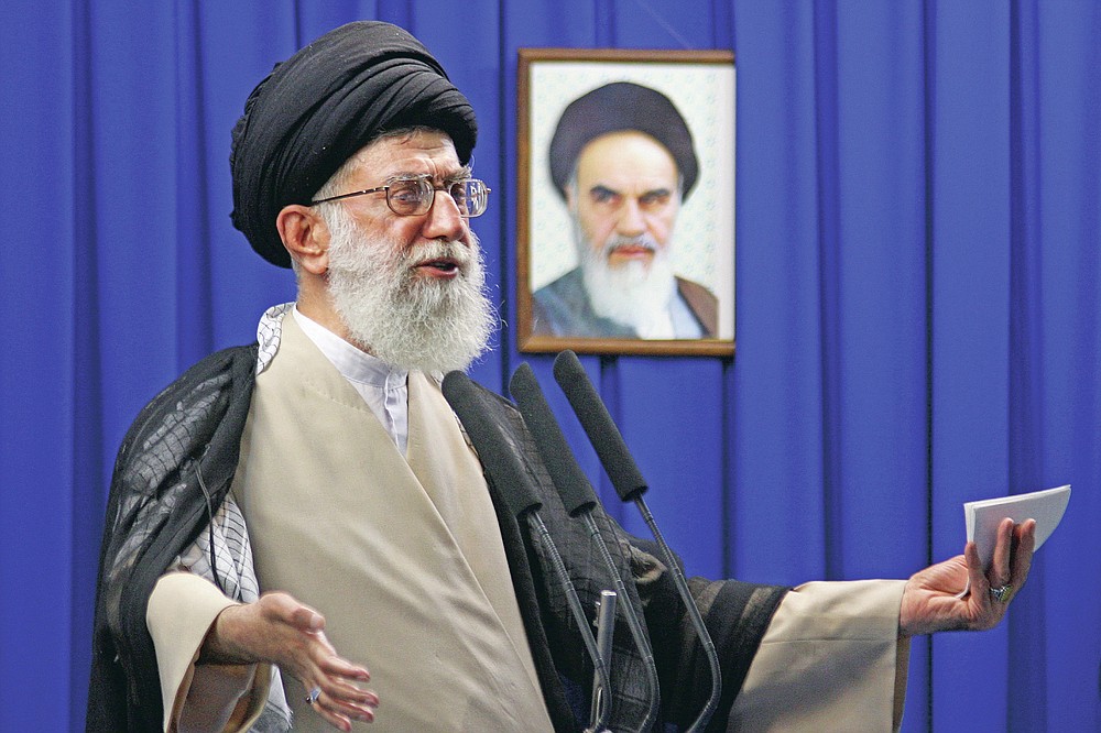 FILE - In this June 19, 2009 file photo, Iran's Supreme Leader Ayatollah Ali Khamenei delivers a sermon with a picture of the late spiritual leader Ayatollah Khomeini in the background, during Friday prayers at the Tehran University campus in Tehran, Iran. Khamenei was among the first and most powerful world leaders to suggest the coronavirus could be a biological weapon created by the U.S. (Meisam Hosseini/Hayat News Agency via AP, File)