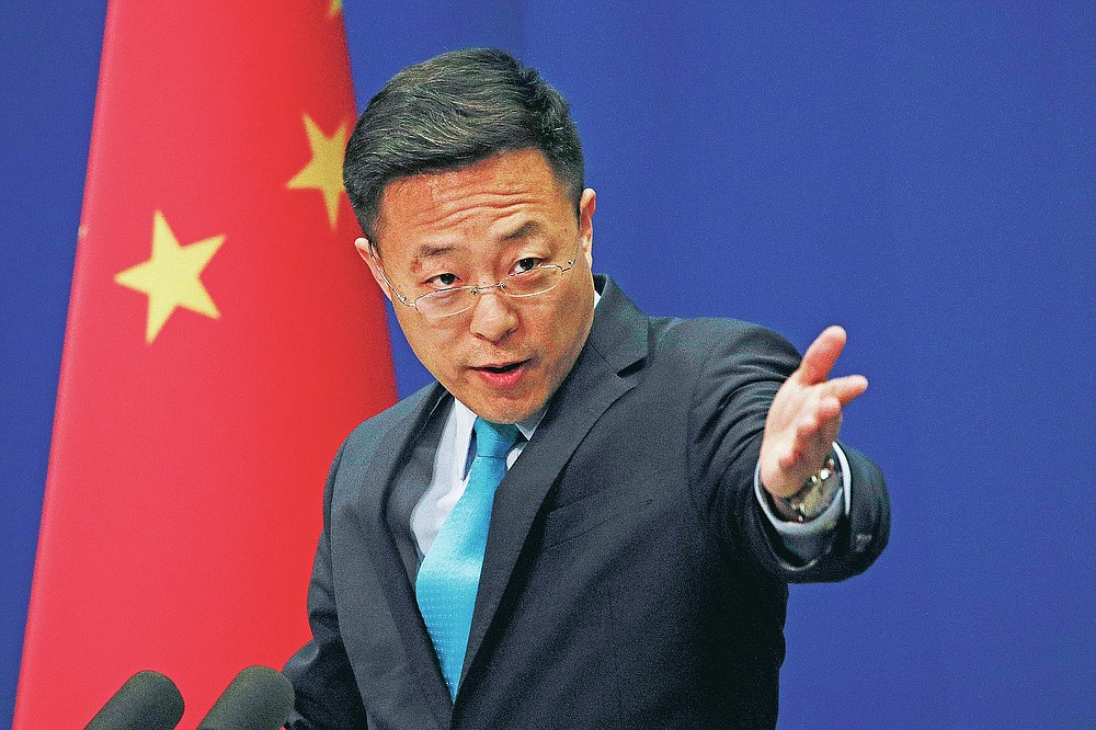 FILE - In this Monday, Feb. 24, 2020 file photo, Chinese Foreign Ministry spokesman Zhao Lijian speaks during a daily briefing at the Ministry of Foreign Affairs office in Beijing. Zhao has repeatedly suggested on Twitter that the coronavirus might have come from the U.S. Army. (AP Photo/Andy Wong, File)